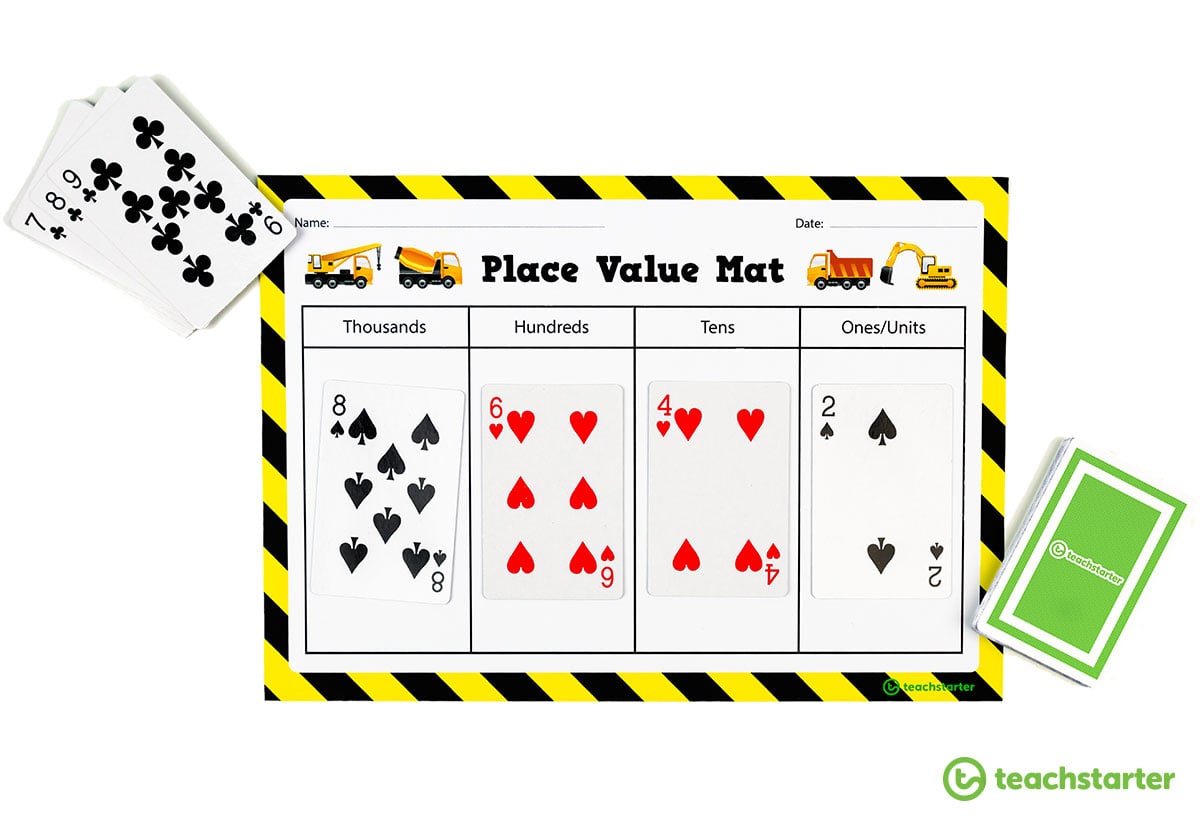 place value mat with playing cards on it