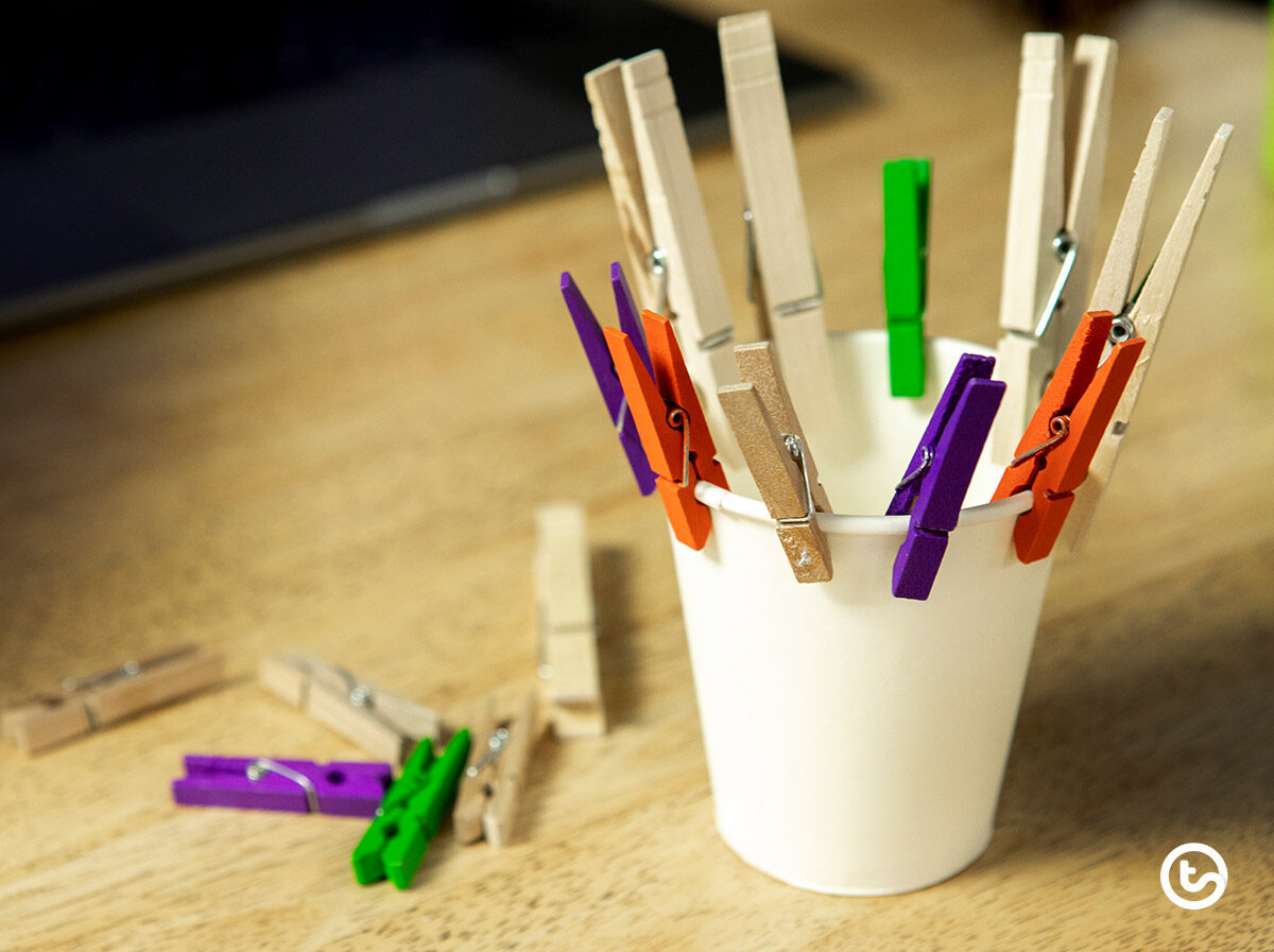 fine motor skills activity clothespins on a cup