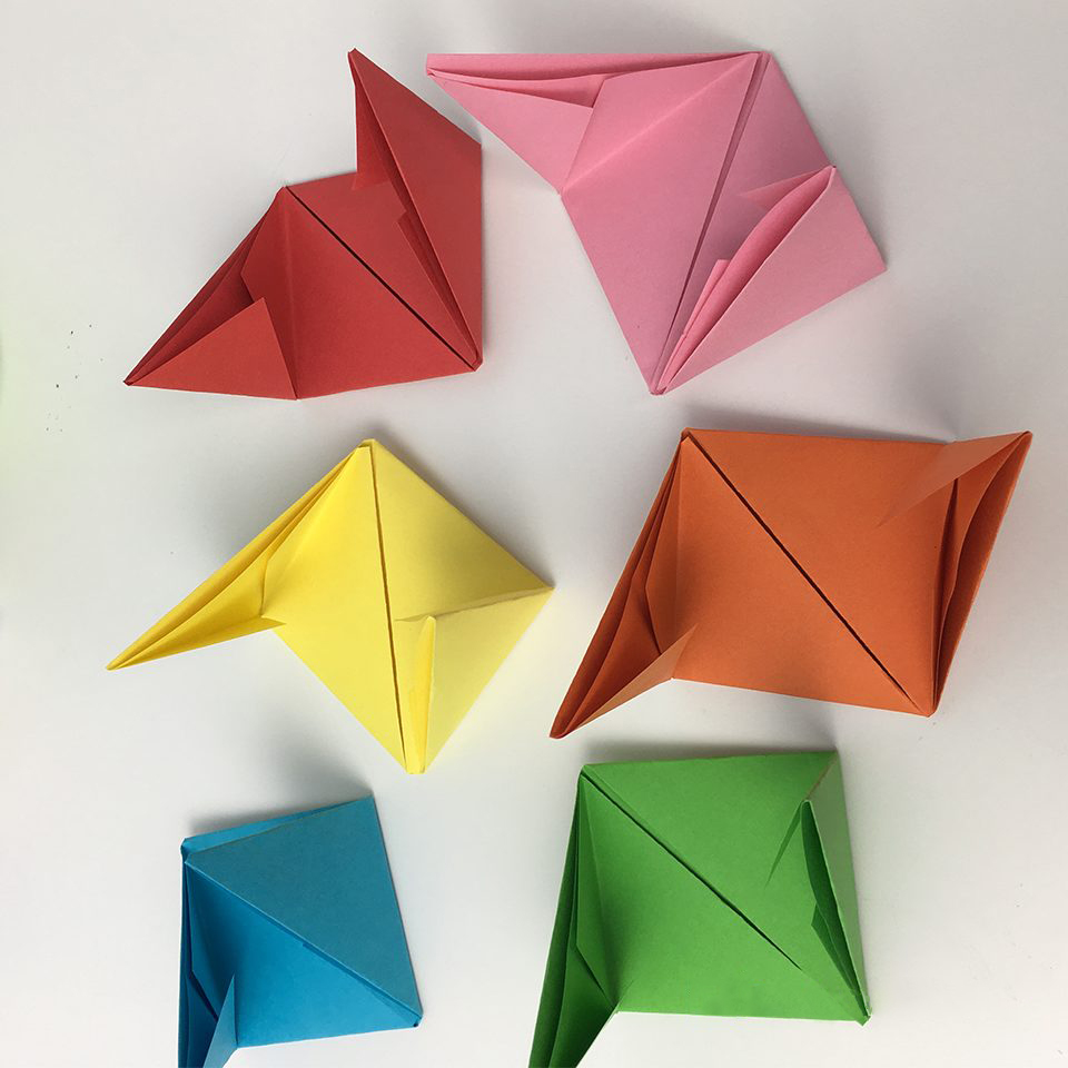 folded pieces of colored paper for making an origami box