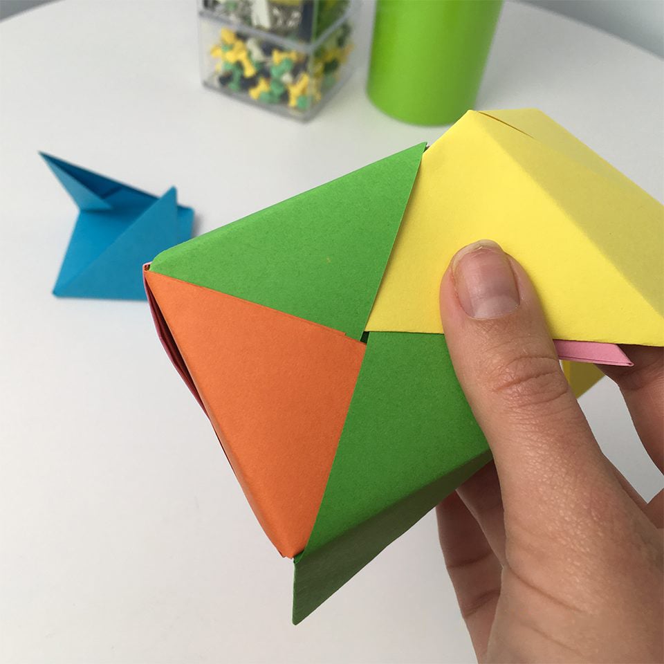 hand on final step of making origami box