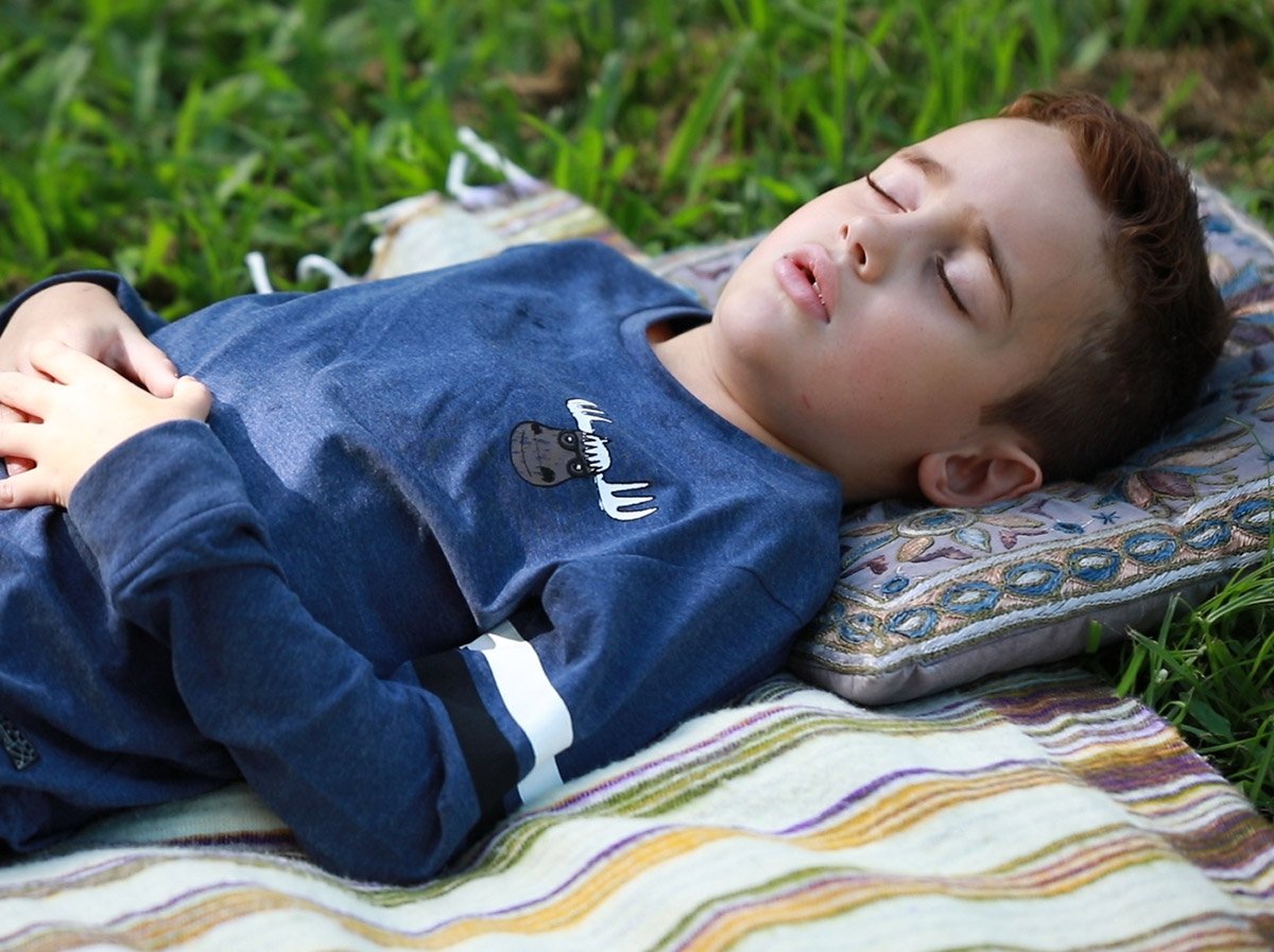 Young boy doing mindful breathing.