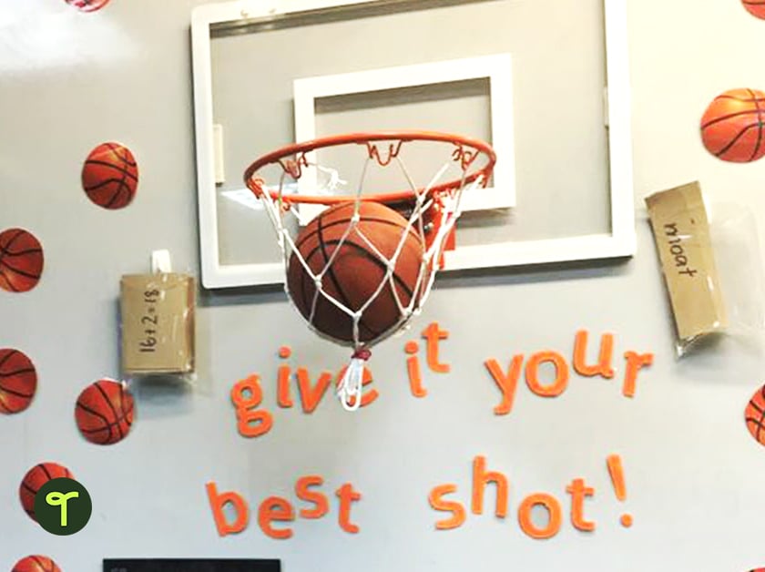 classroom whiteboard with a basketball hoop and the words give it your best shot! in orange letters