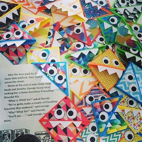 monster themed corner bookmarks piled up on a teacher's desk