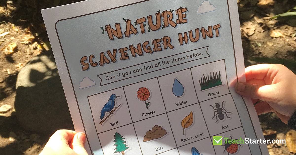 child's hand holding a colour page featuring a nature scavenger hunt