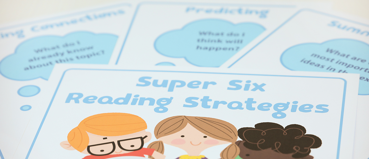 The words Super Six Comprehension Strategies appear on flashcards in a classroom