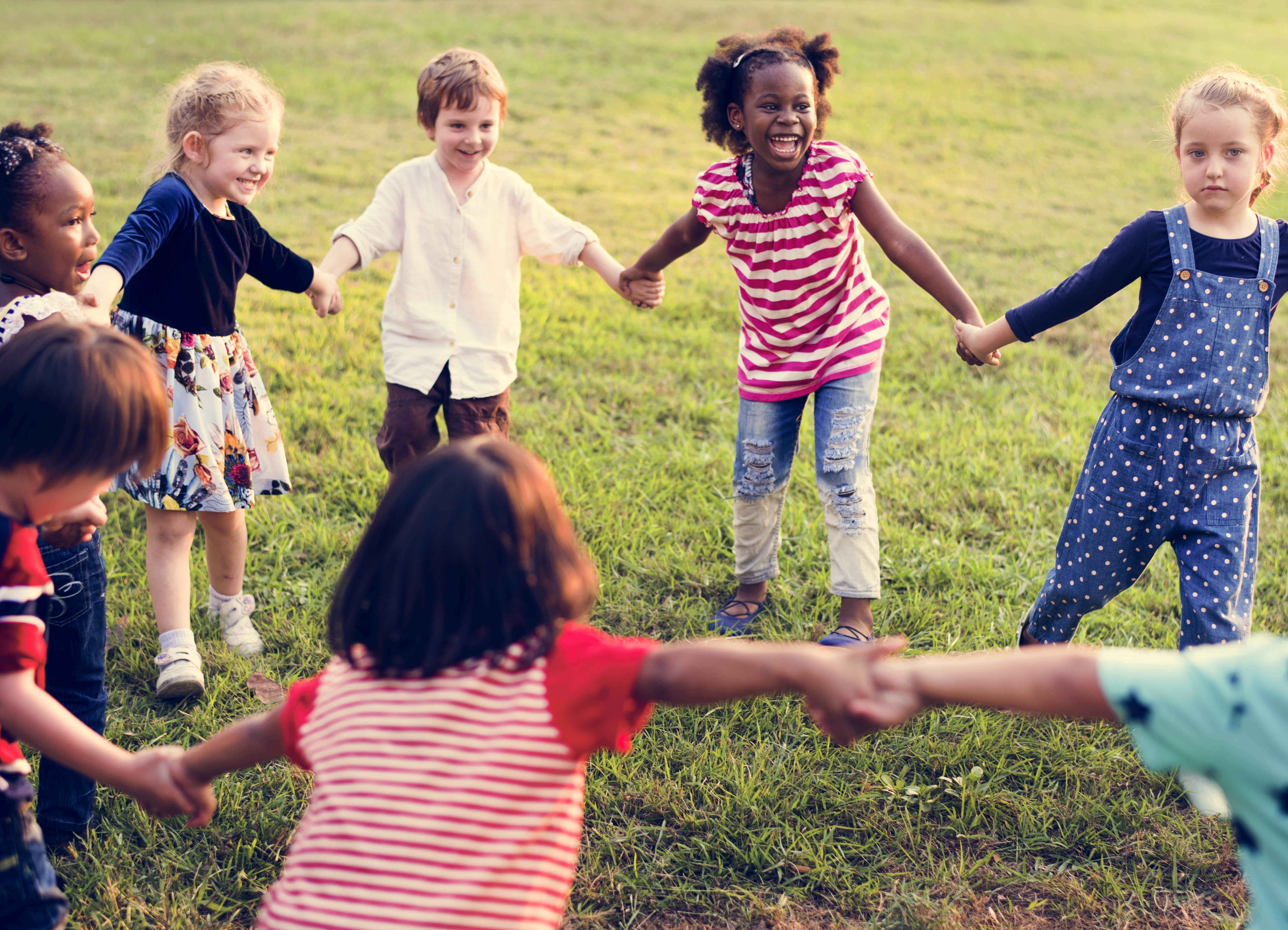 kids playing drama games, standing in a circle holding hands