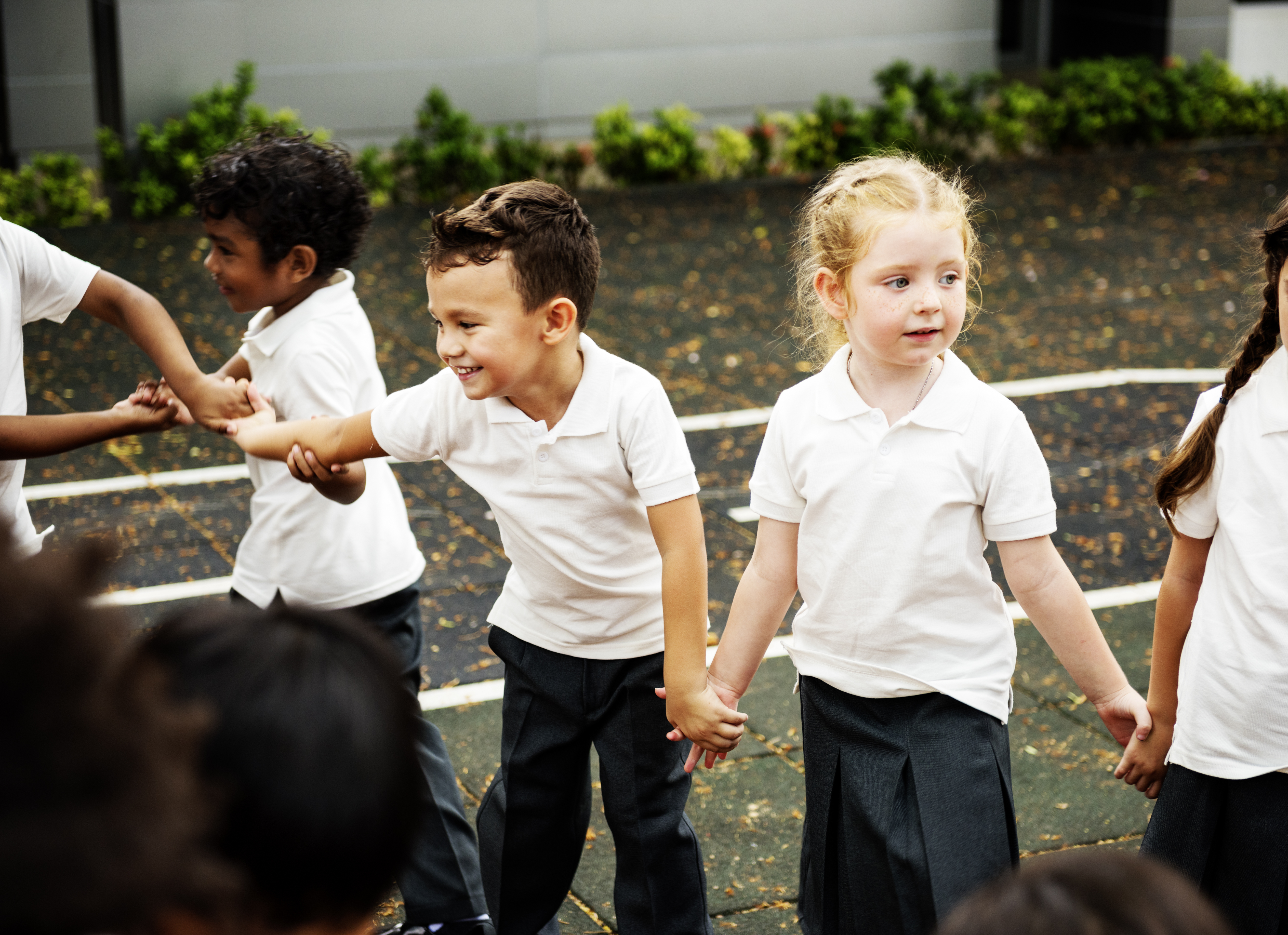 kids playing drama games, standing in a circle holding hands