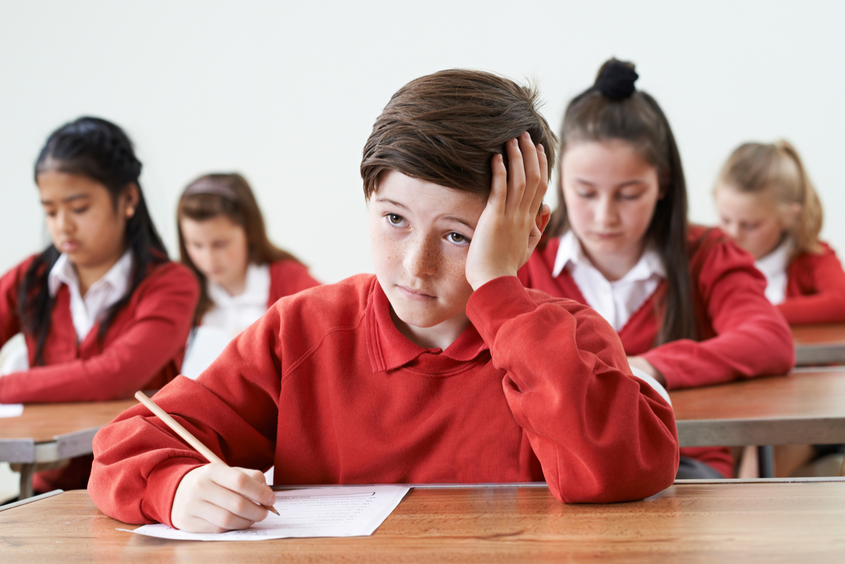 student sitting at a desk looking up. How teaching mindfulness improves student learning.