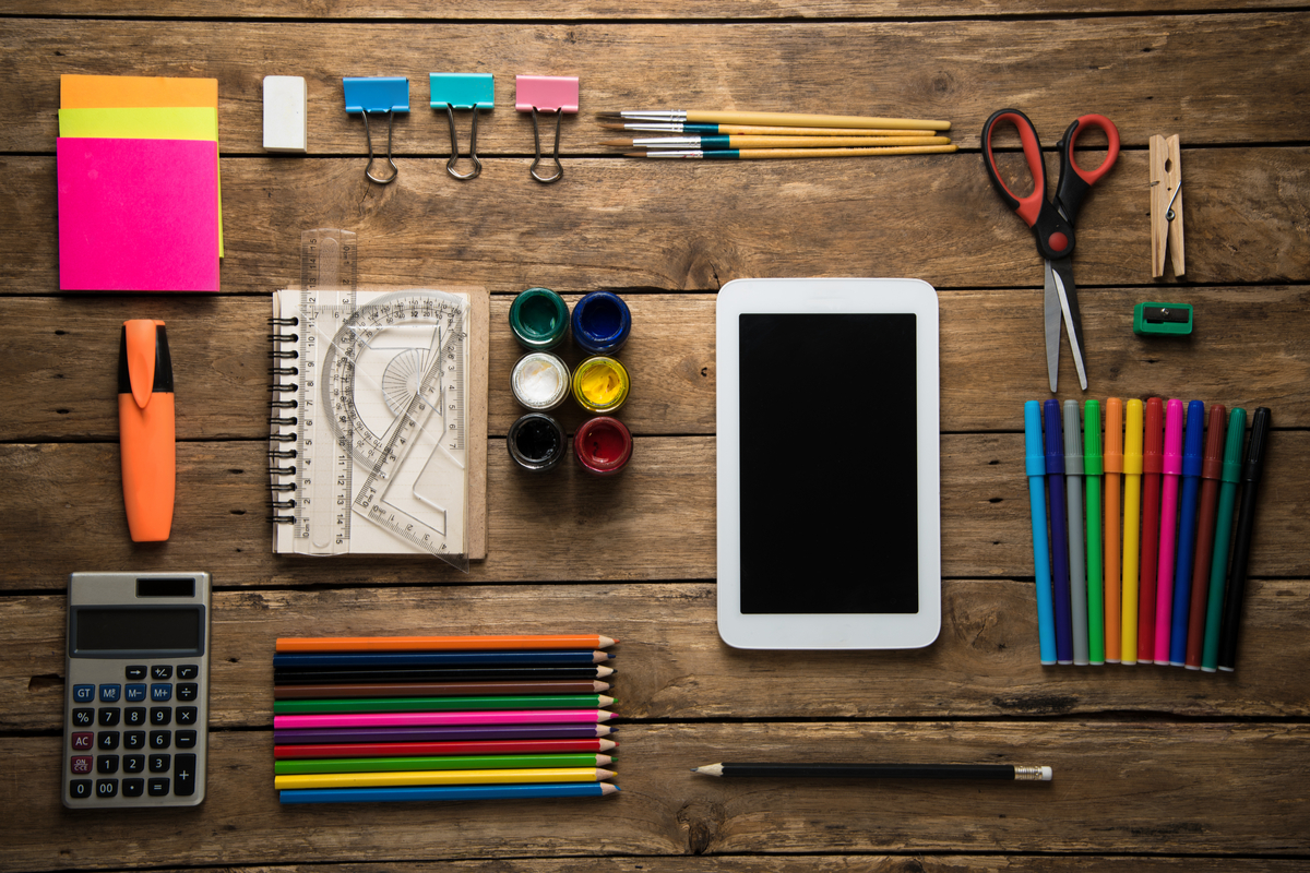 wooden desk with stationary - time management tips for teachers