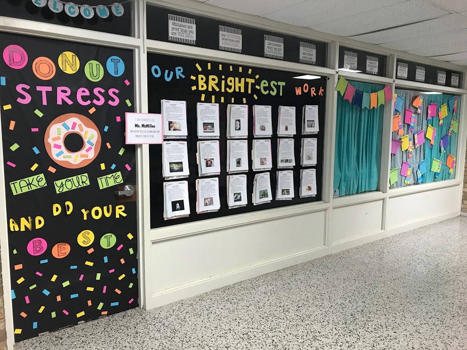 Student work display wall and motivational quote on classroom door