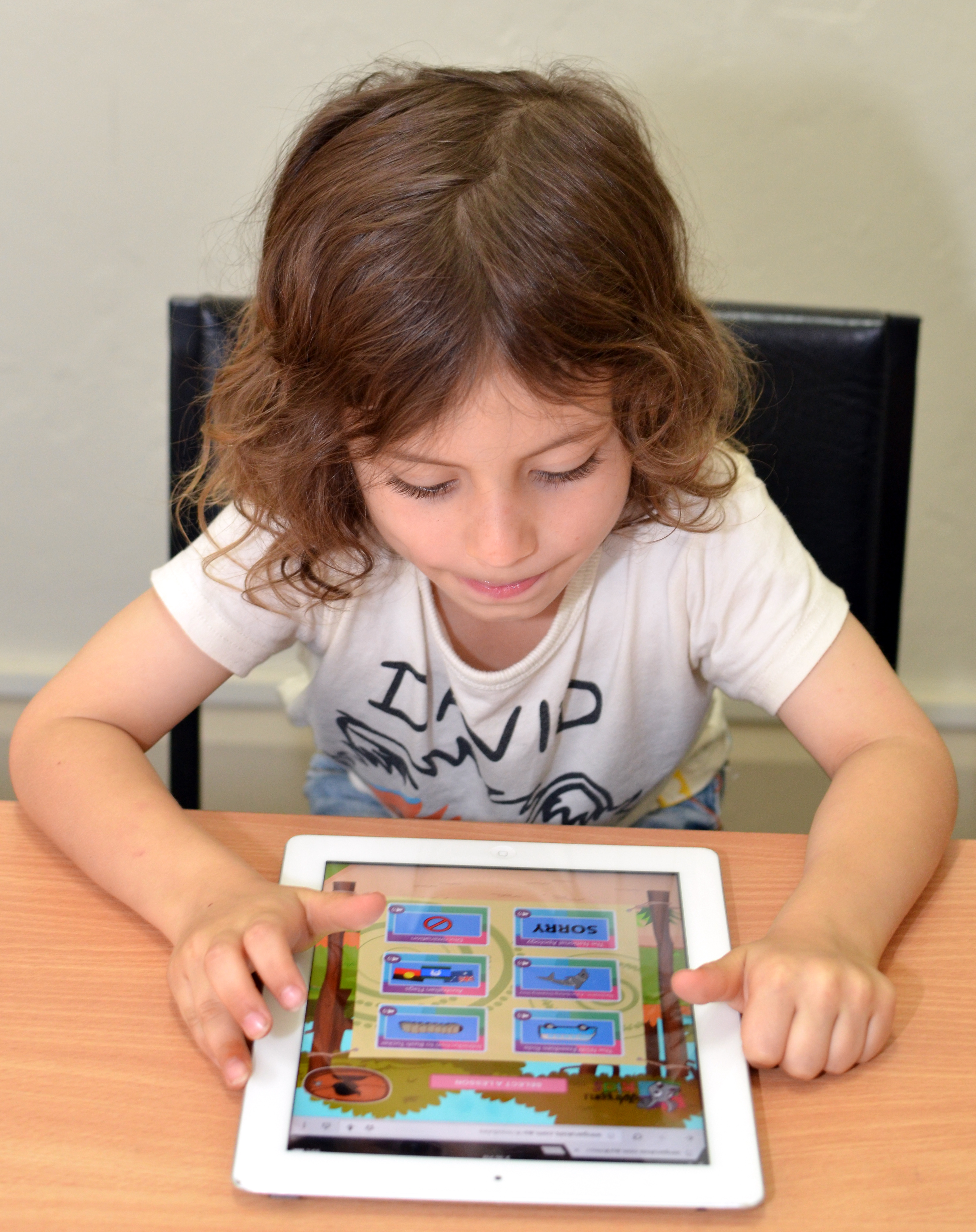 Child with brown hair using the Wingaru Kids Aboriginal Studies teaching resources on an ipad