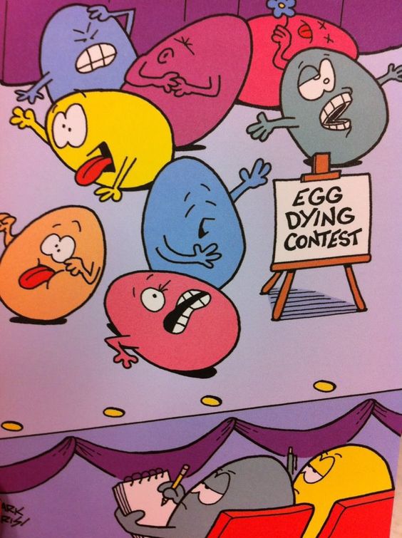 coloured eggs on a stage pretending to die beside a sign saying 