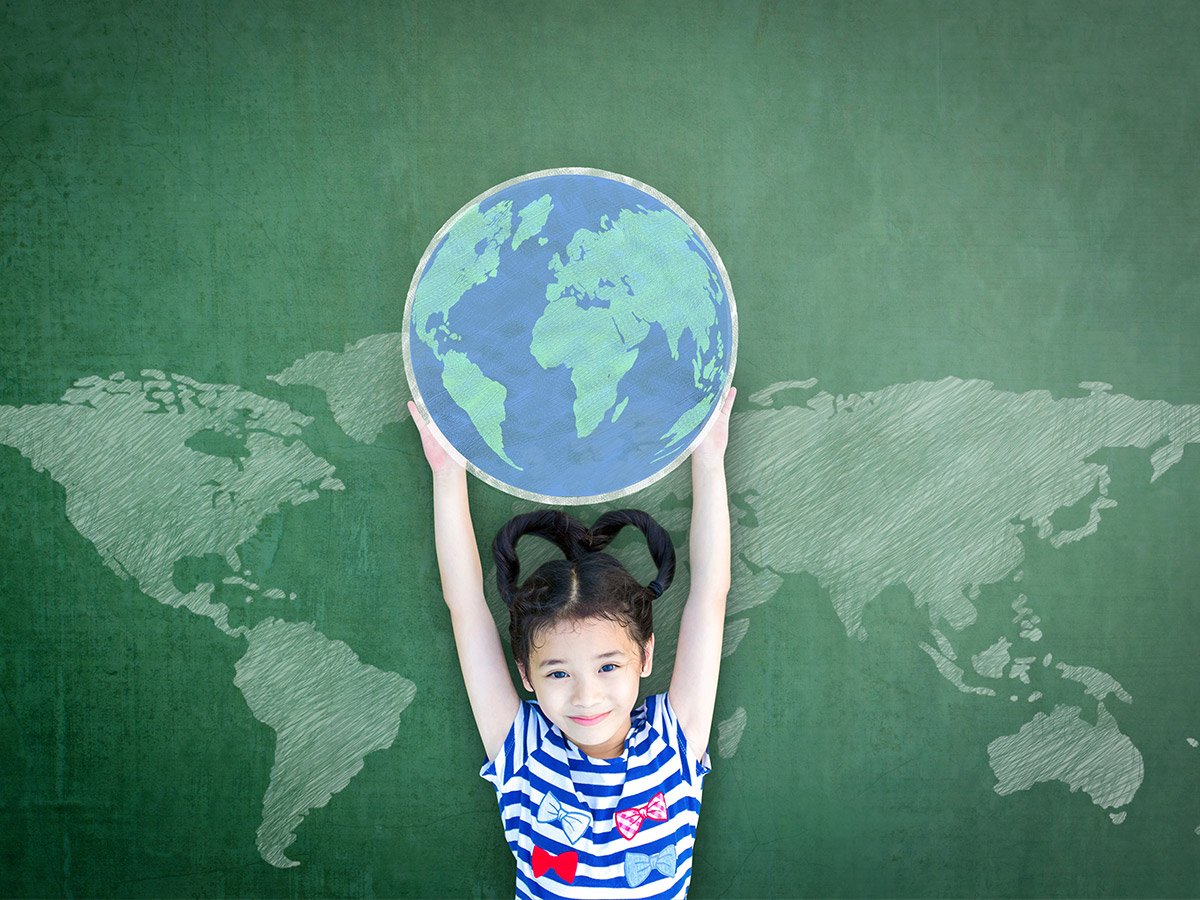 child holding up a globe