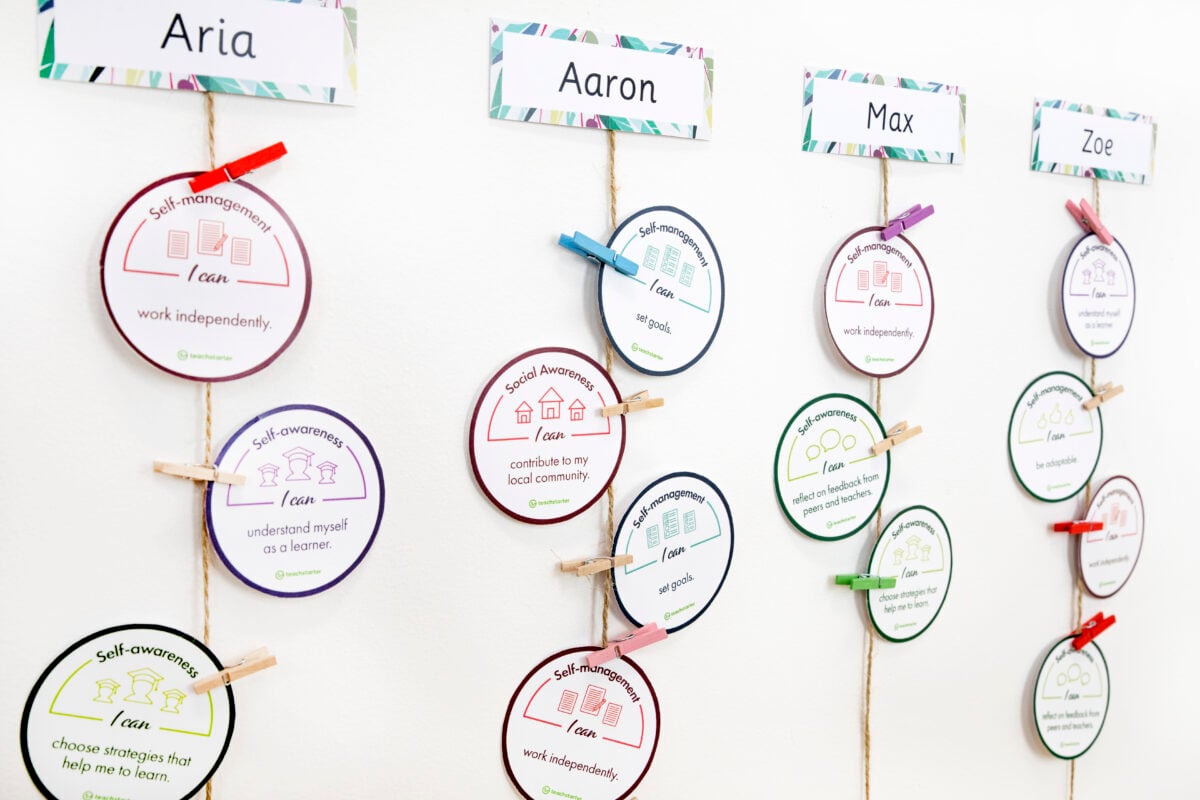 life skills badges for kids hanging from string on the wall with small paper clips attached