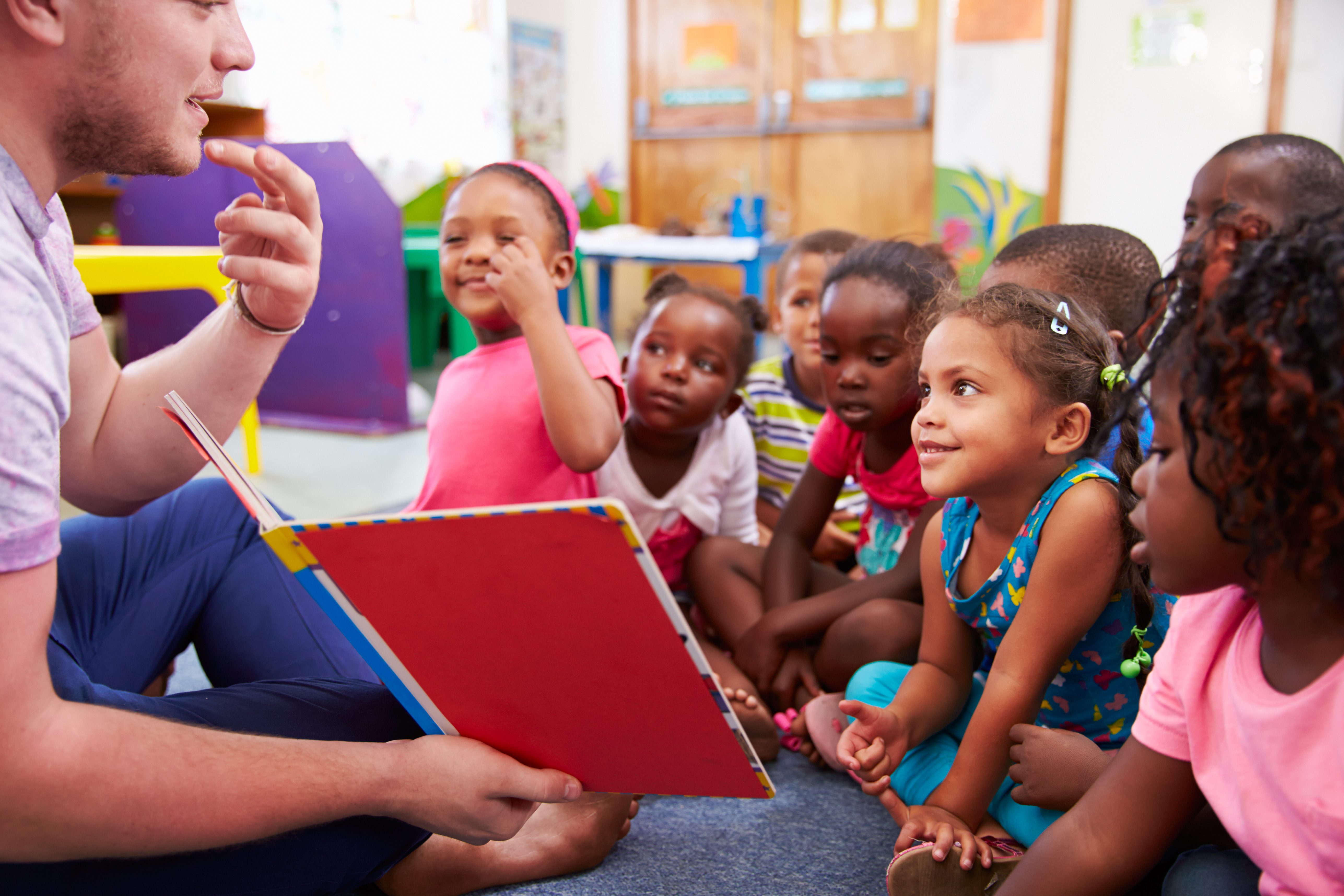 male teacher introducing a lesson to students with a lesson hook