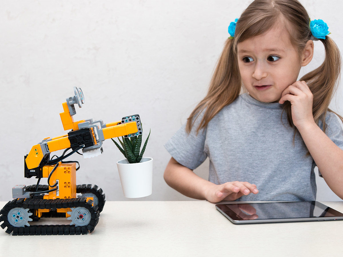 girl coding a robot using an ipad