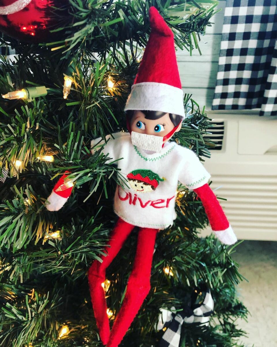 Elf on the Shelf wearing a mask in a Christmas tree