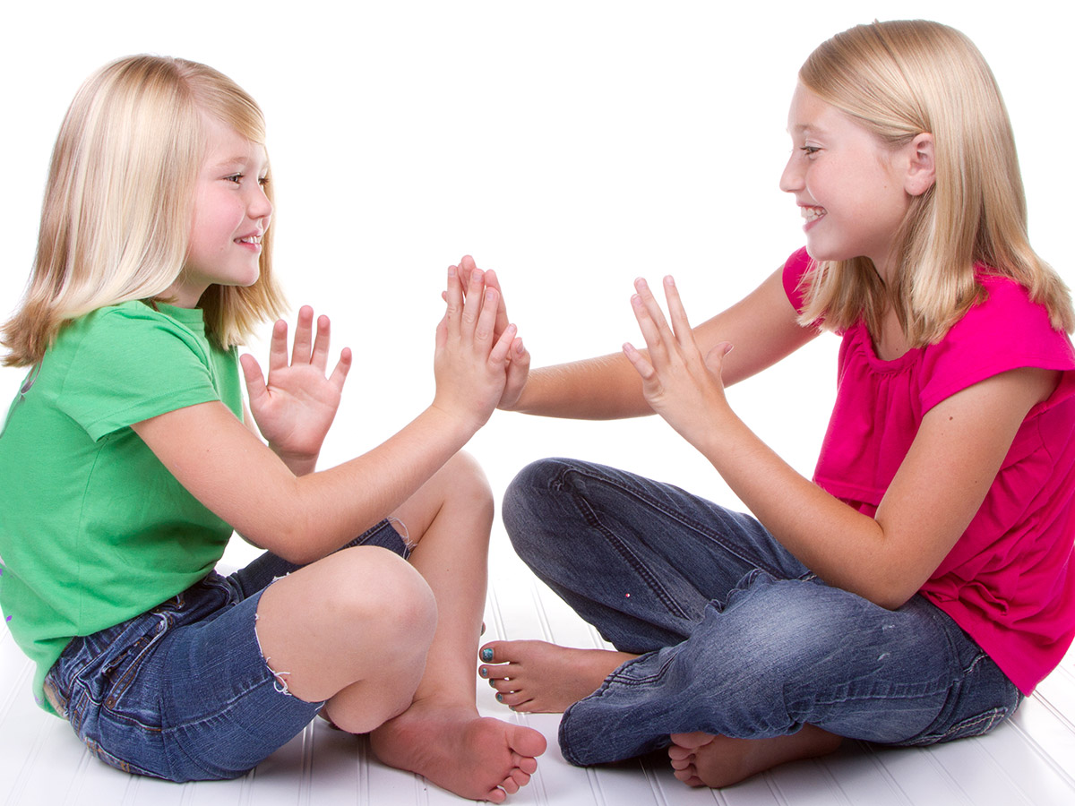 Girls playing clapping games
