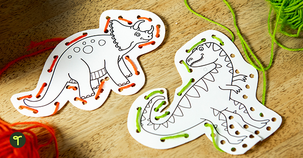 student's completed dinosaur fine motor activities sit on a desk
