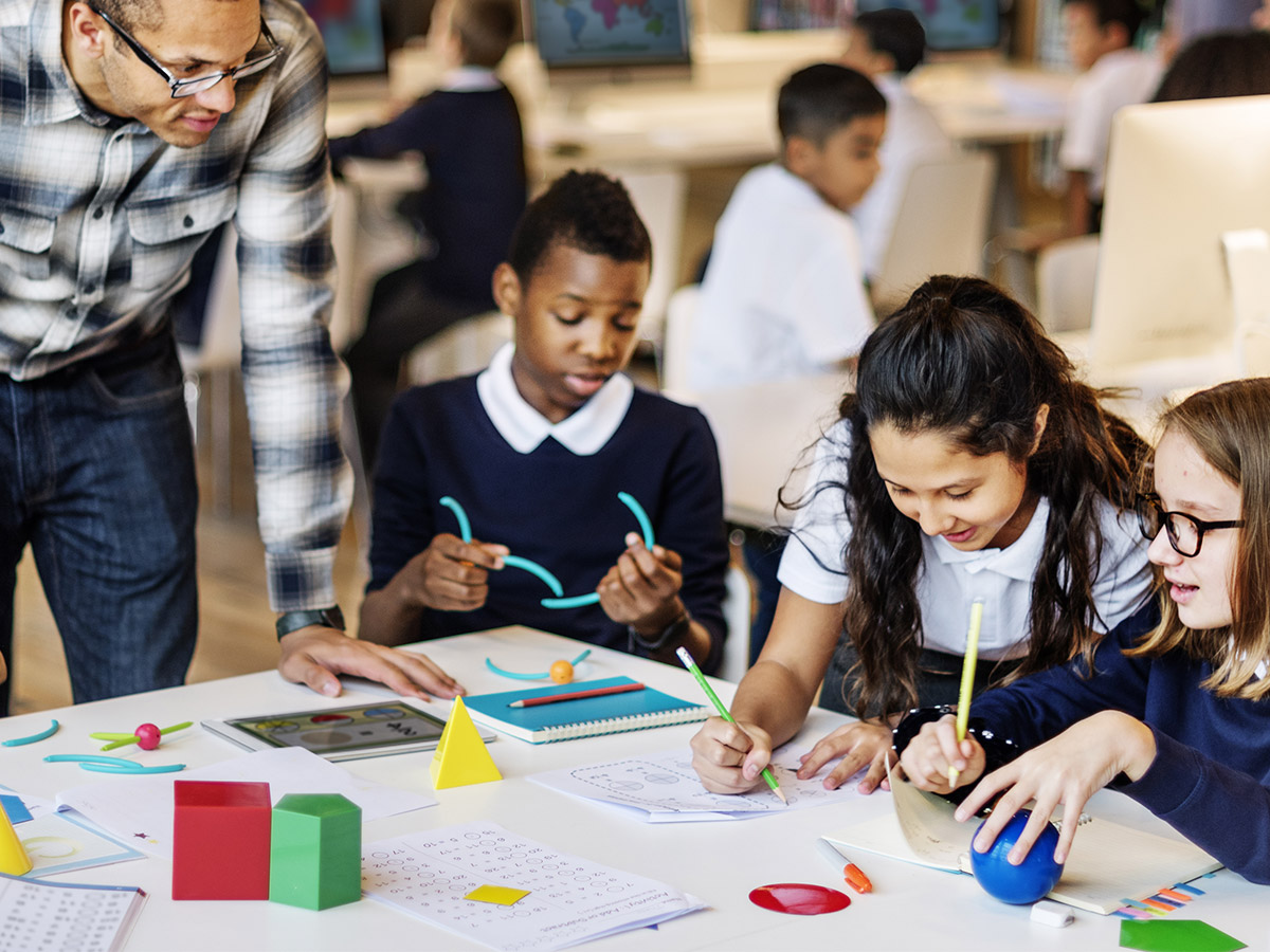 Teacher working with small group of students for maths instruction