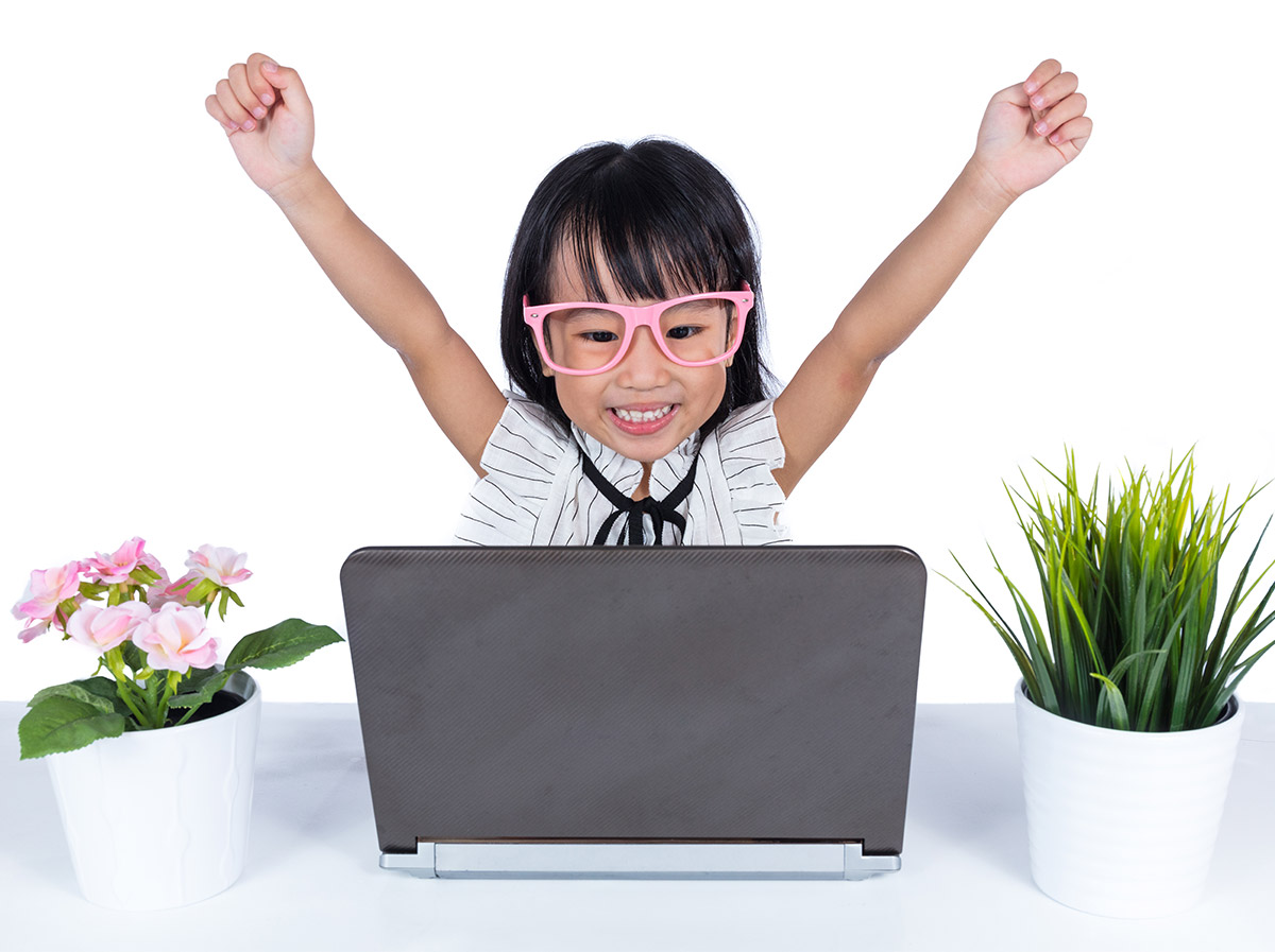 Girl excited to be working on laptop