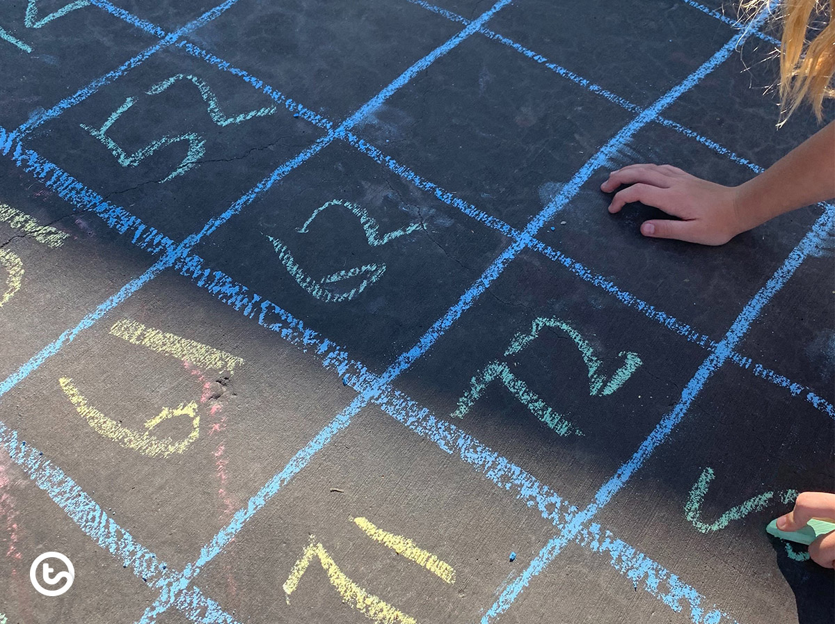 Create a giant hundreds chart using sidewalk chalk.