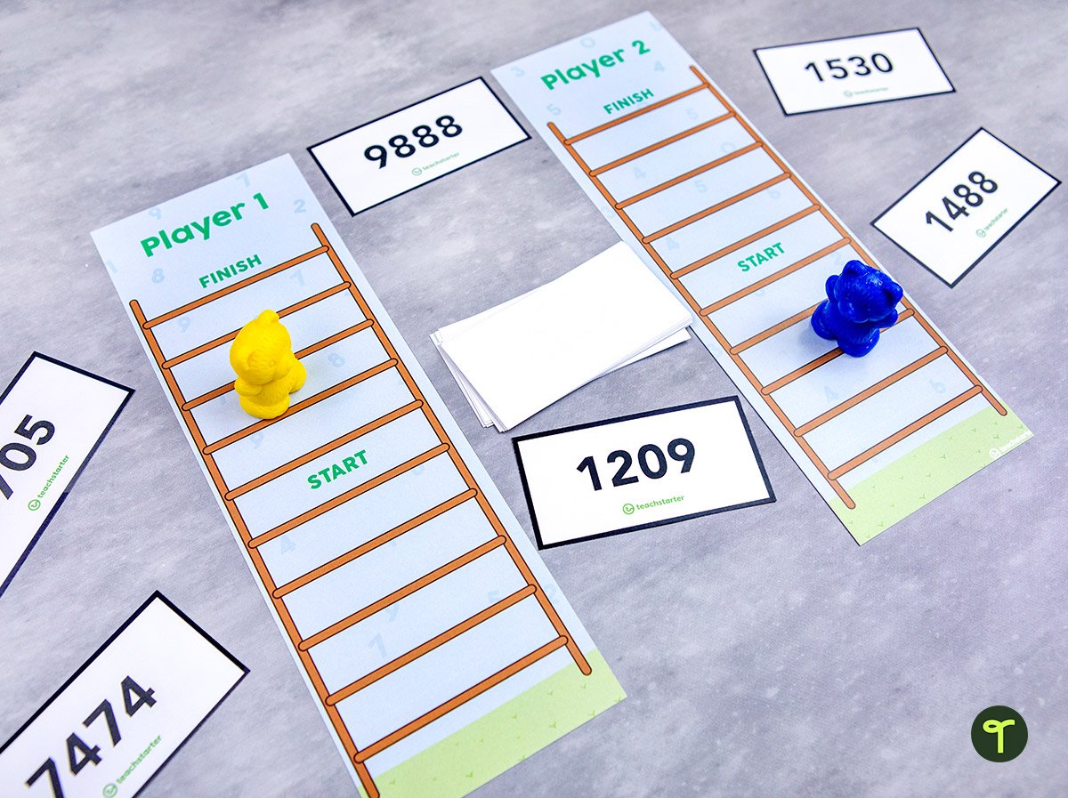 ladder place value game sits on a desk; there are plastic teddy bear manipulatives on top of it