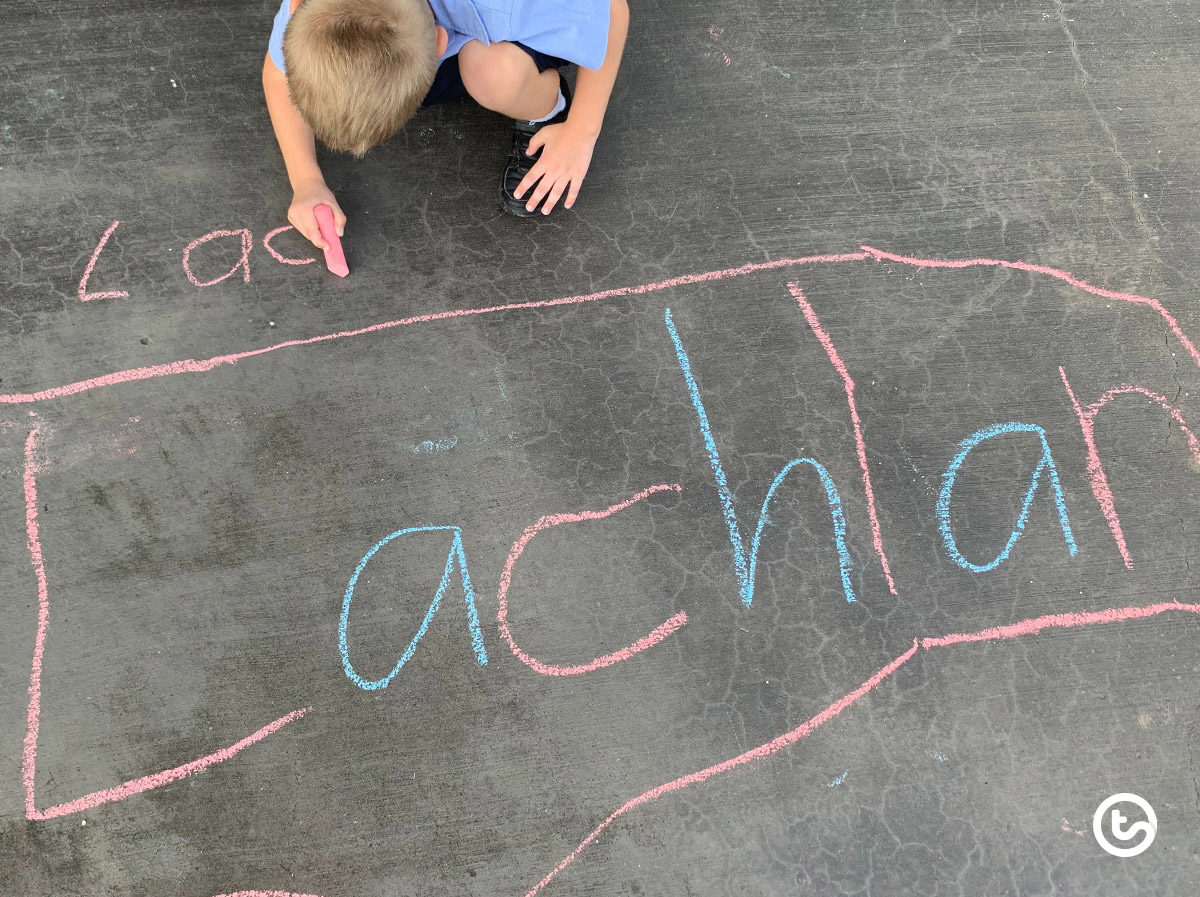 Practice writing words using sidewalk chalk on cement.