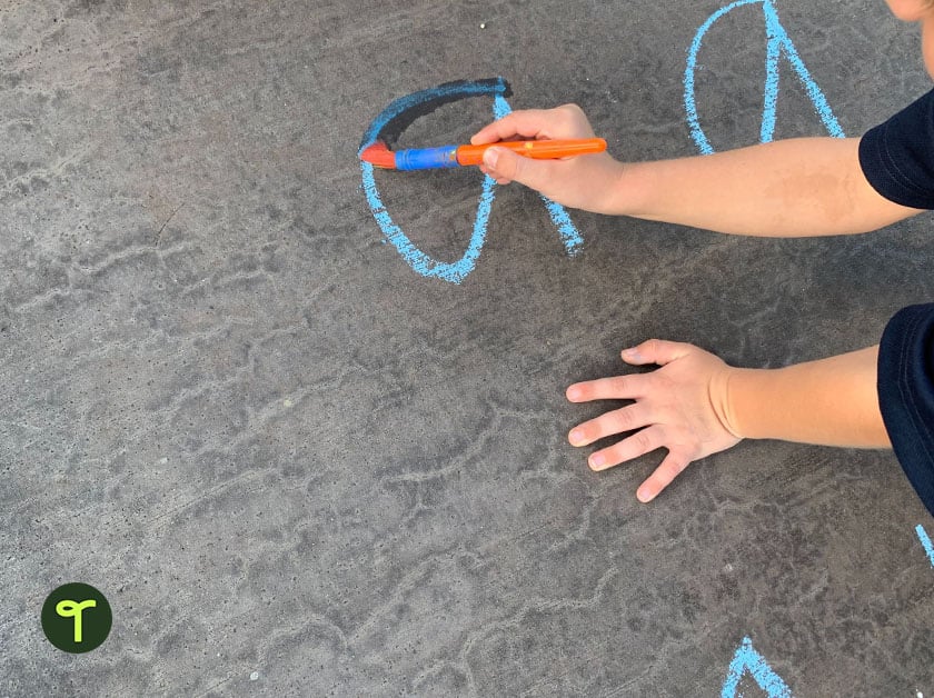 writing letters in sidewalk chalk