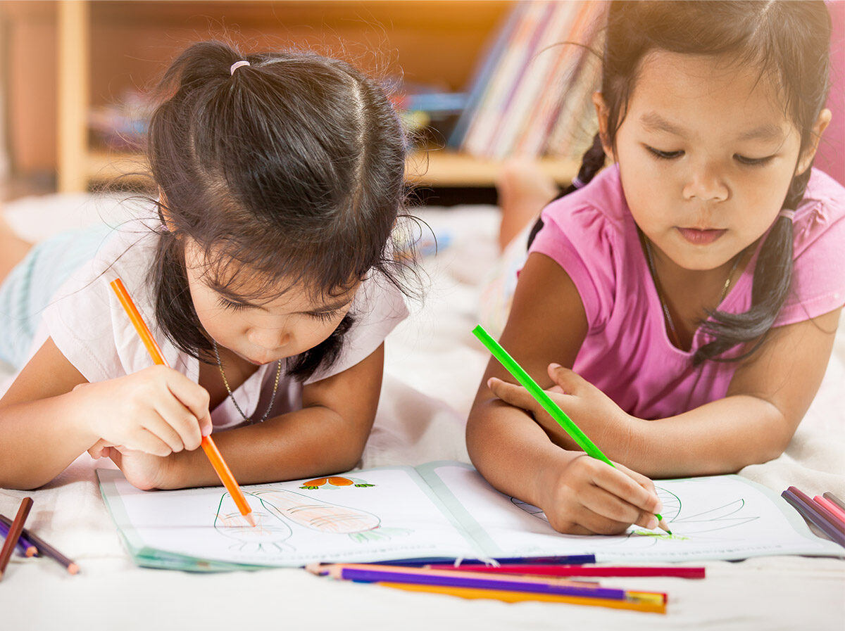 Children colouring in on the floor