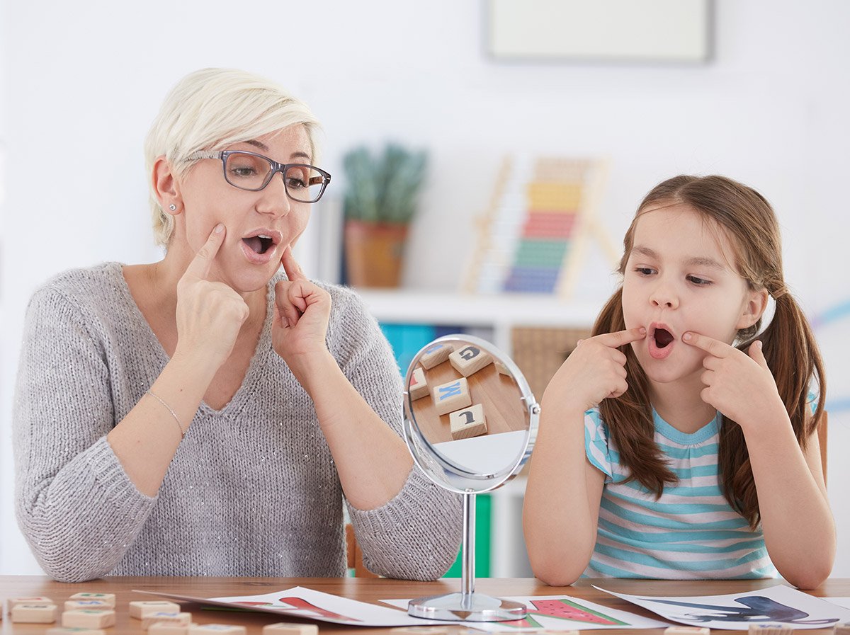 a teacher works with a child on sounds