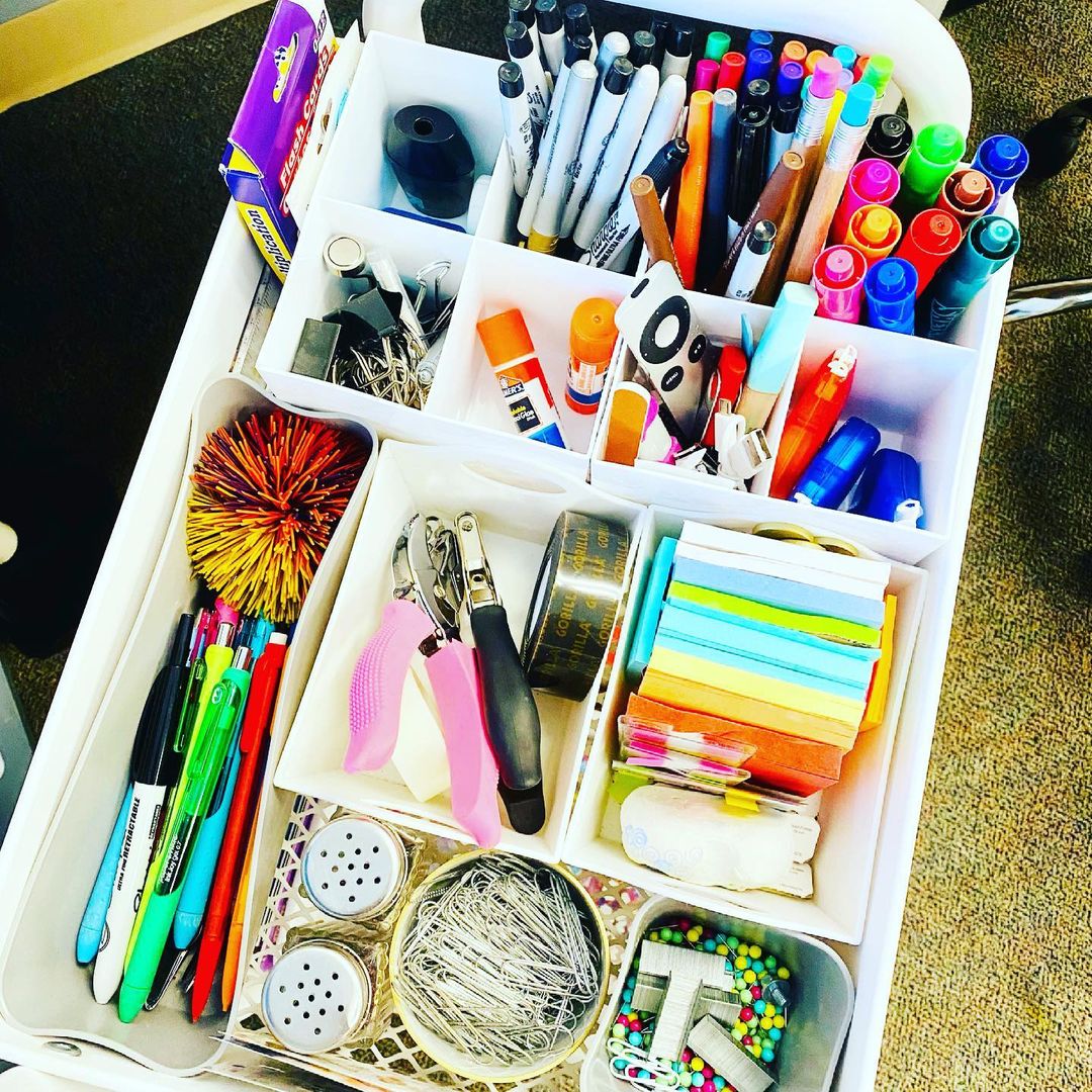 teacher's rolling cart full of supplies