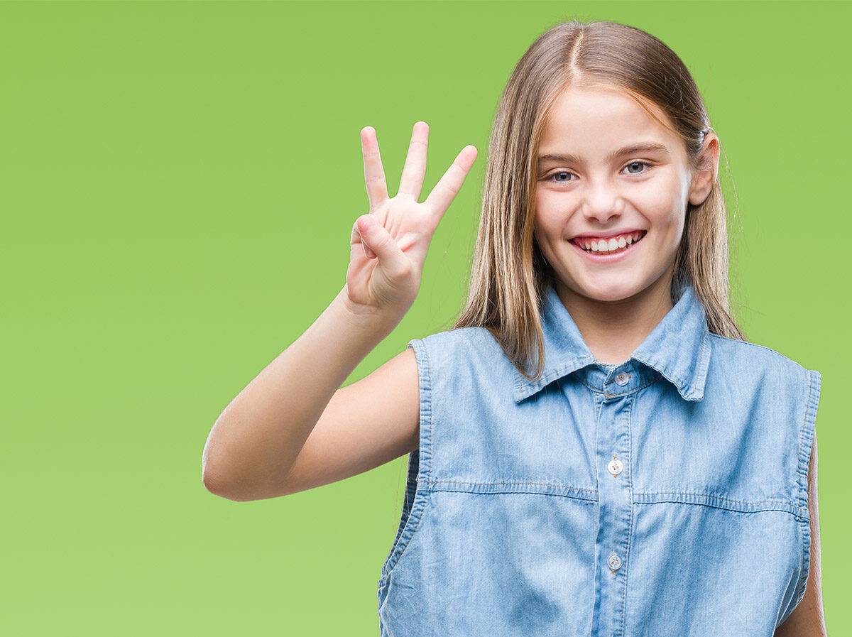 Girl holding up three fingers