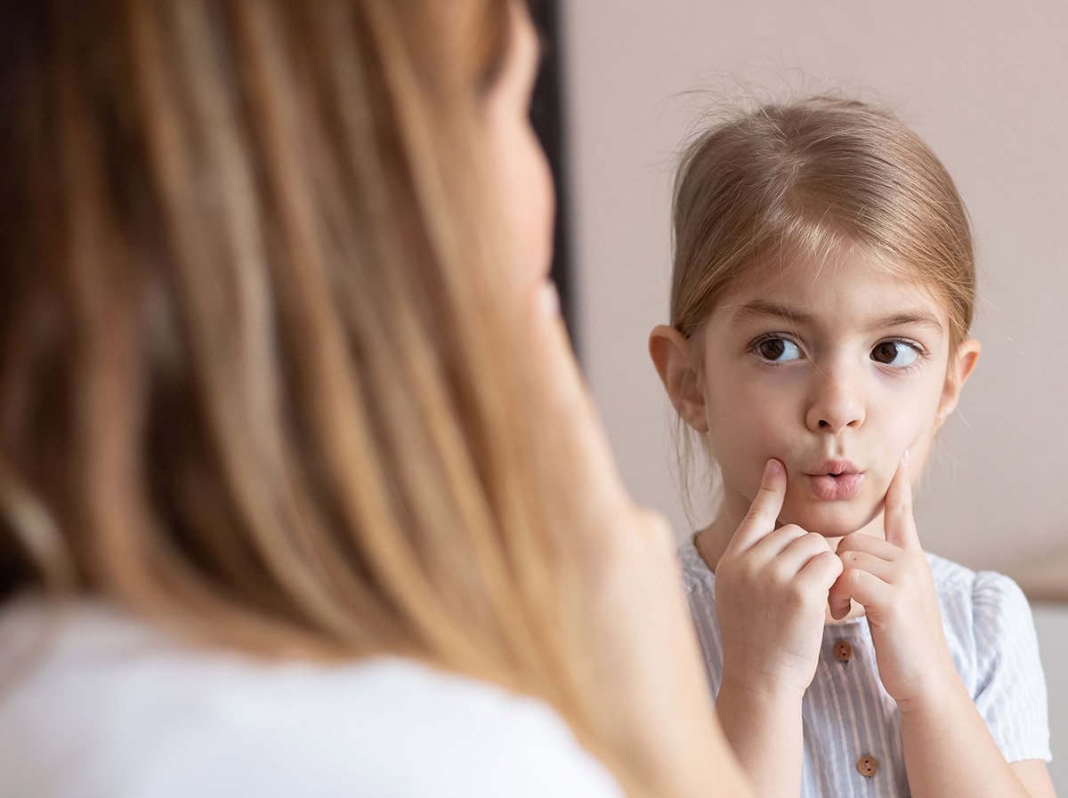 child making 'oo' sound with mouth