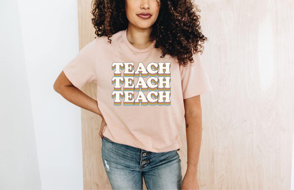 woman wearing a t-shirt that reads teach teach teach