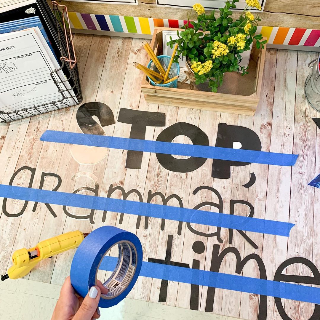 painter's tape trick for hanging bulletin boards featuring words stop, grammar time
