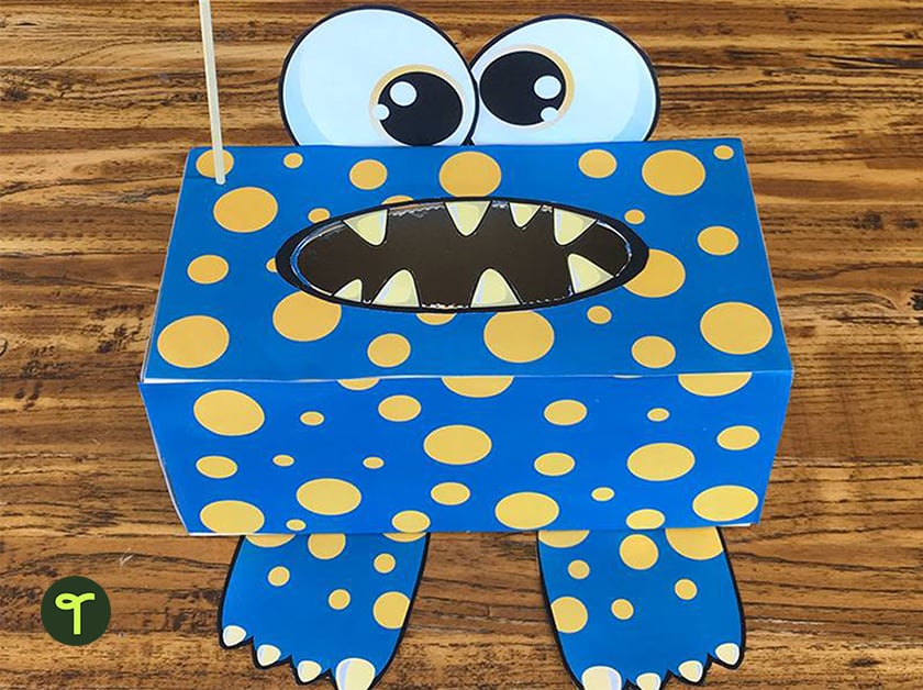 tissue box decorated to look like a monster sits on a teacher's desk