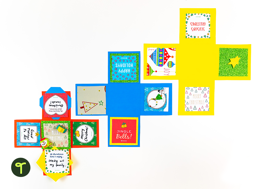 Three Christmas Paper Craft Boxes Open on Table - Teach Starter