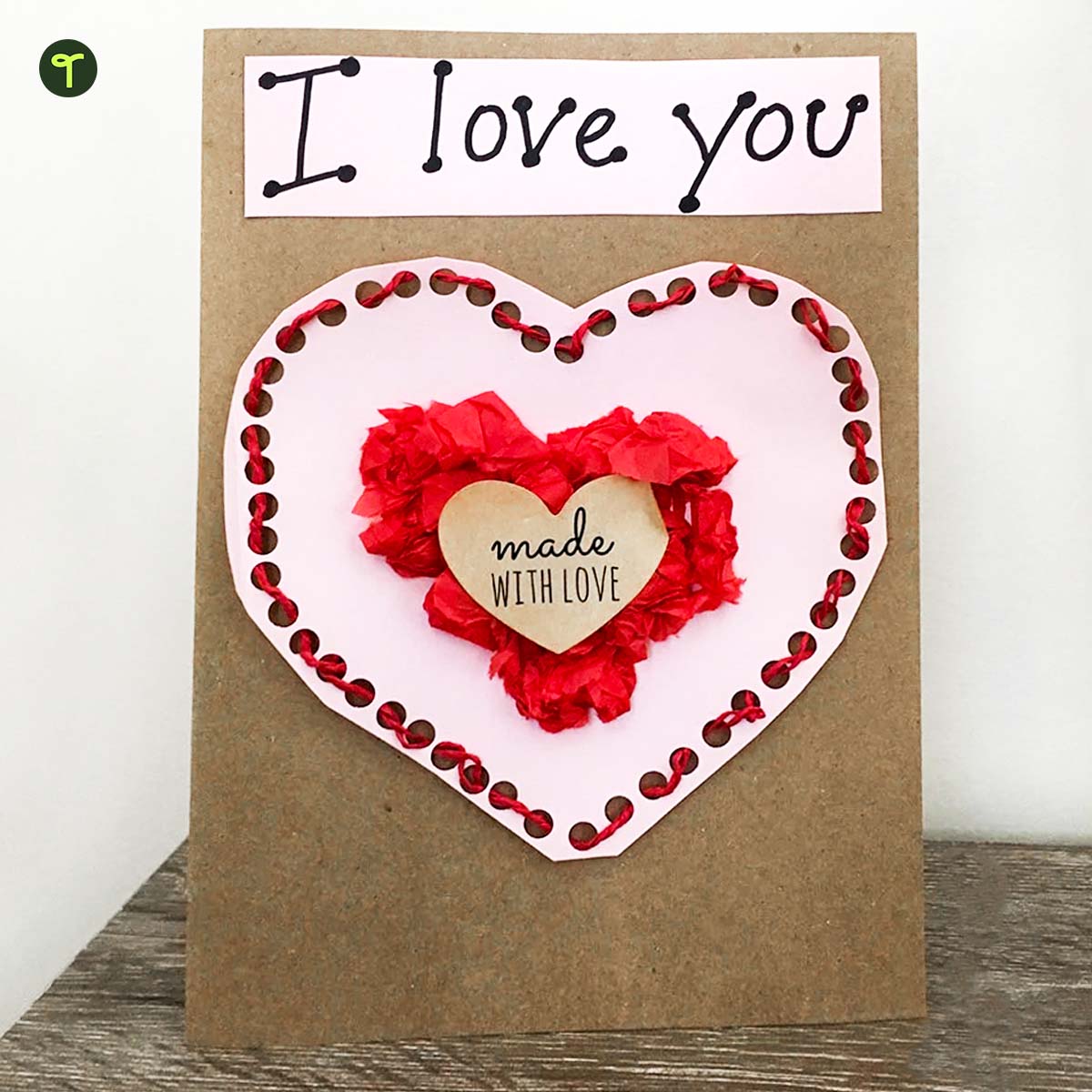 Valentine's Day craft idea for kids featuring a threaded heart in the center to work kids'fine motor skills