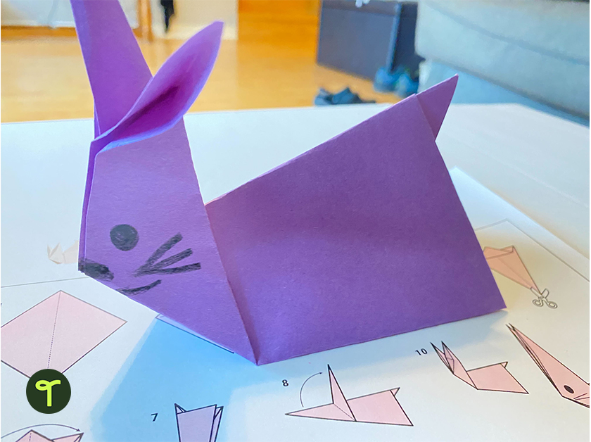 an origami rabbit made with purple paper