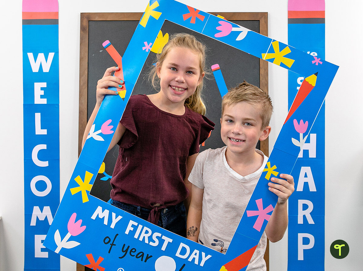 printable first day of school photo frame being held by 2 children