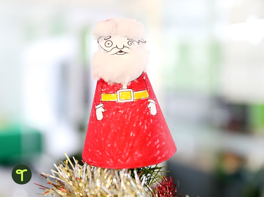 printable Santa Christmas tree topper printable sitting on a christmas tree