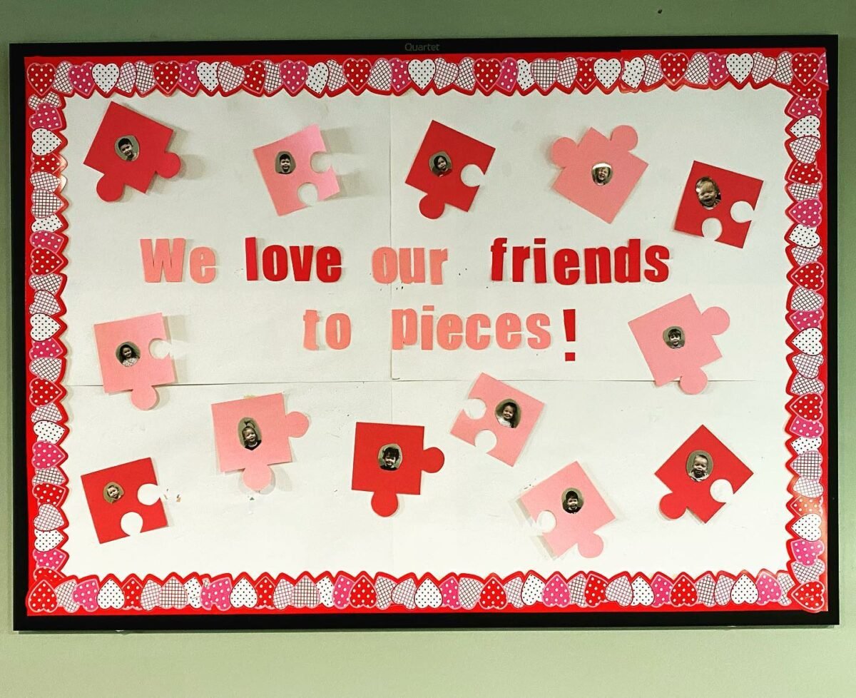 We love our friends bulletin board with puzzle pieces in red and pink - Teach Starter