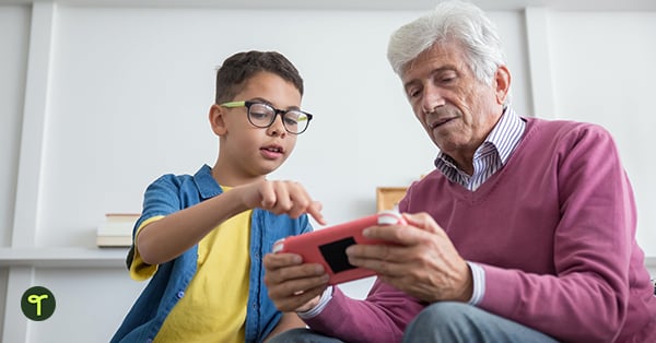 kid helping older person with device