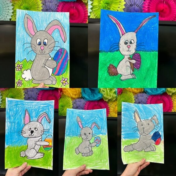 Student art examples of Easter bunnies holding eggs 