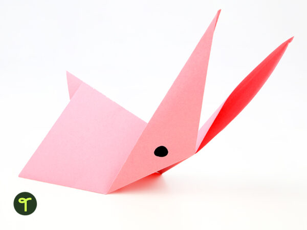 Pink origami rabbit with white background