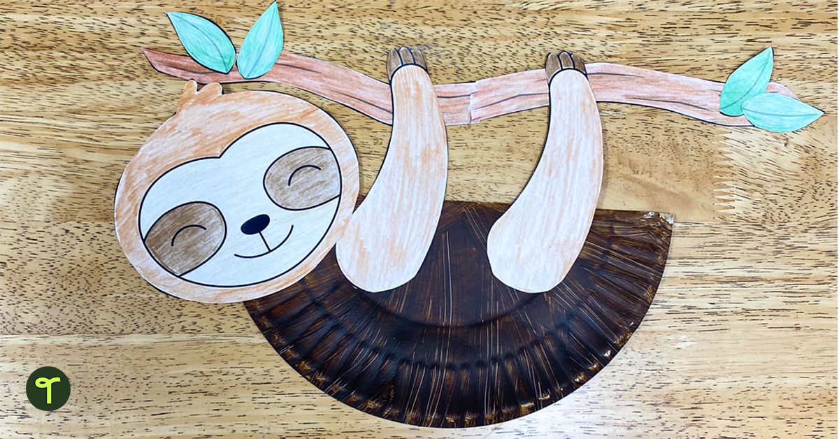 Sloth craft made from a paper plate sits on a student's desk