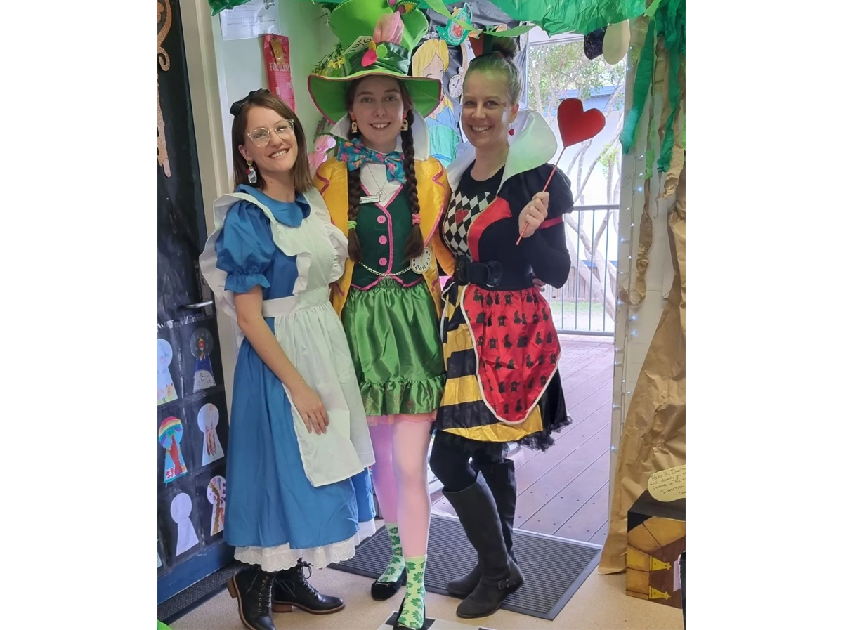 Three woman dressed in costumes from Alice in Wonderland for Book Week