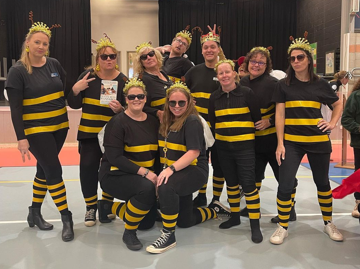 A group of teachers dressed up in black and yellow bee costumes for Book Week