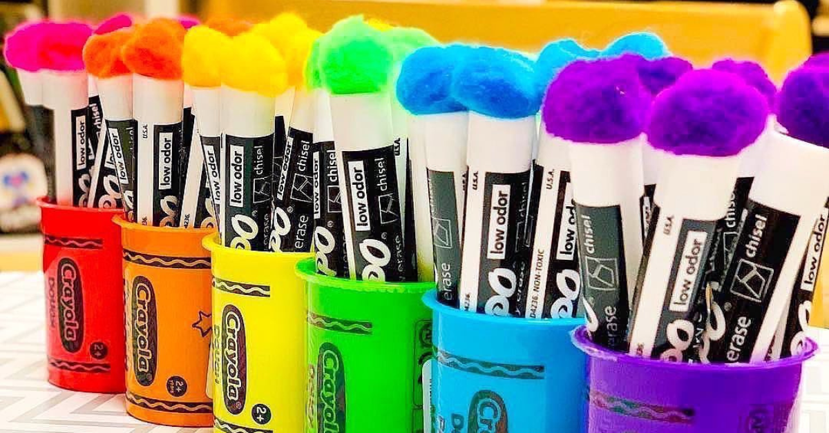 Rainbow colored Expo dry erase markers in colorful containers.